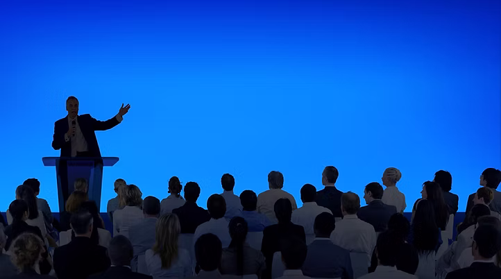 Corporate businessman giving presentation at large event