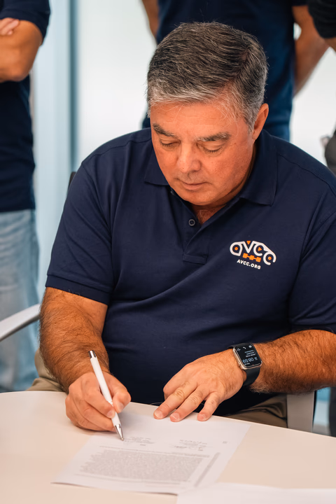 Armando signing a partnership agreement between 2 technical consortia